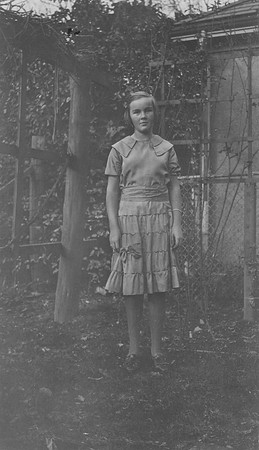 Doris in backyard at grape vine on Elm Avenue